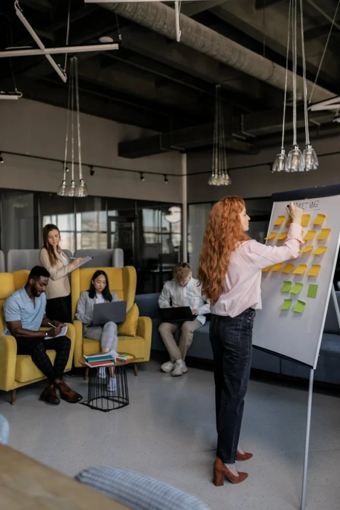 Group of professionals brainstorming and planning using sticky notes during a team meeting.