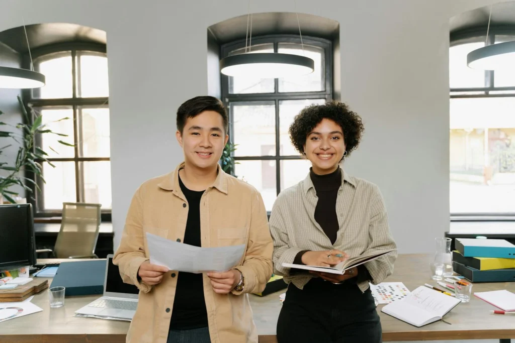 Smiling colleagues planning business strategy in a modern office environment.