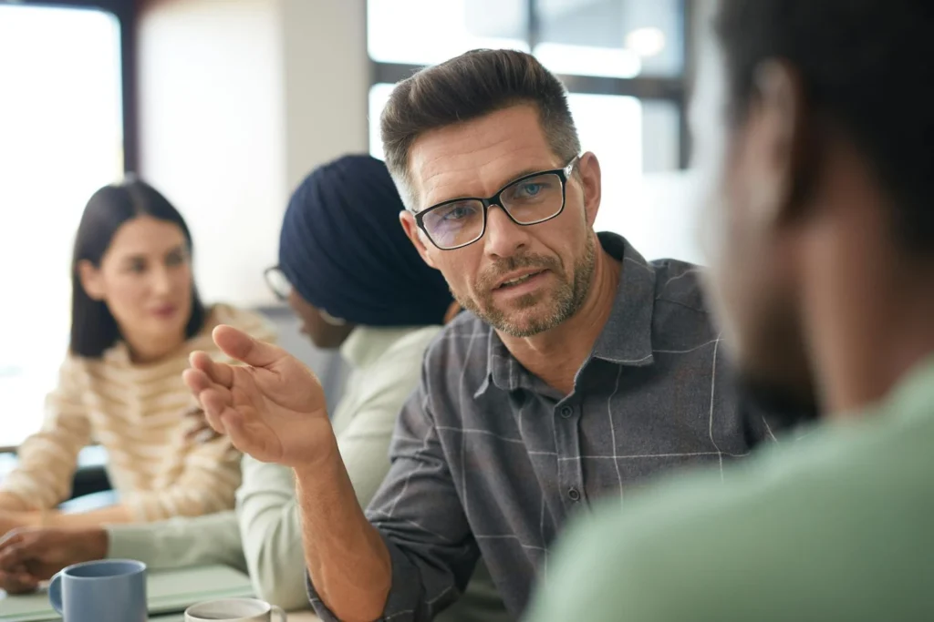 A diverse group having a focused discussion in a modern office setting.