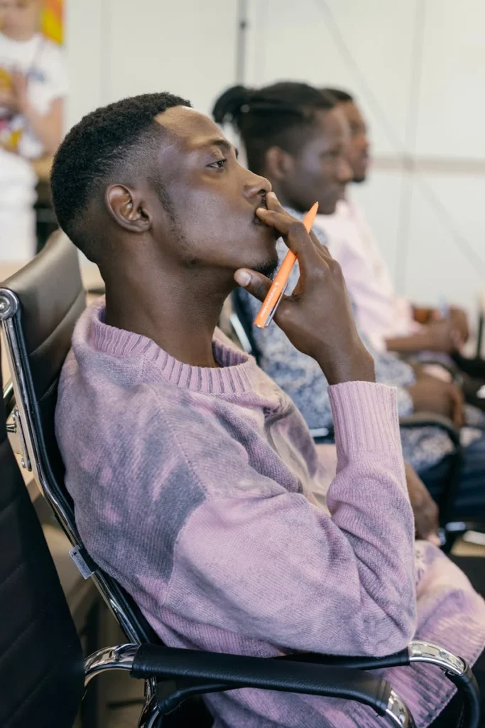 Business professional in a thoughtful pose during a meeting.