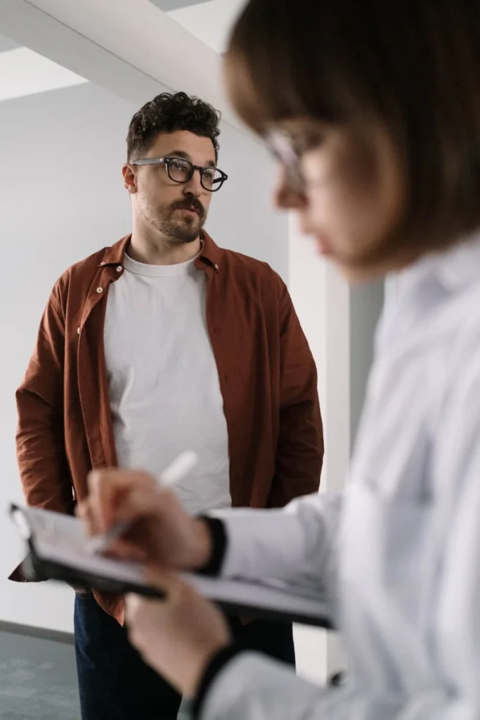 Coworkers engaging in a focused business discussion in a modern office setting.