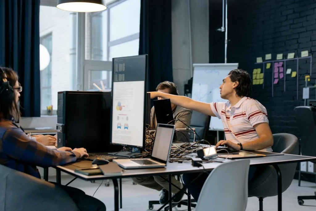 Group of young professionals working on software development in a creative indoor workspace.